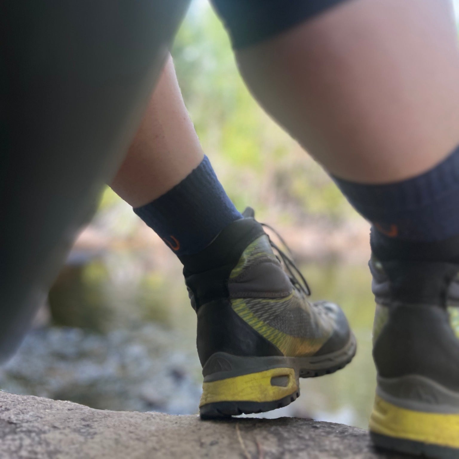 Close-up of hiking boots and socks on a natural outdoor setting