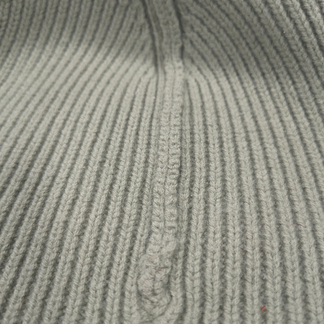 Inside view of 100% merino wool eucalyptus green ribbed knit beanie highlighting soft, warm texture and neat stitching